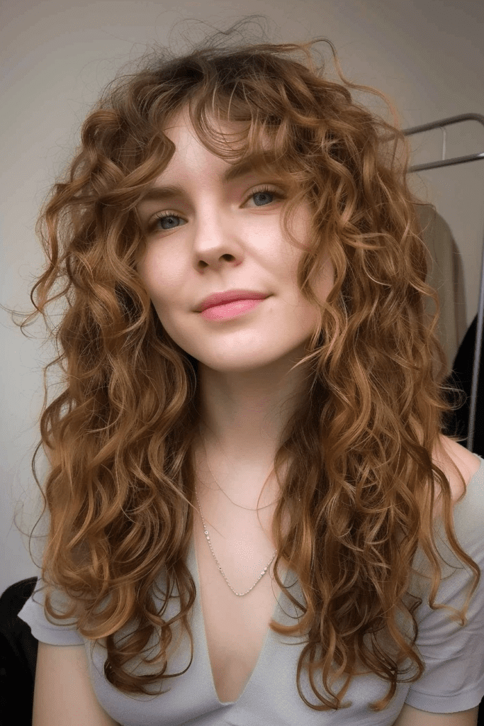 Long Curly Hair with Curtain Bangs